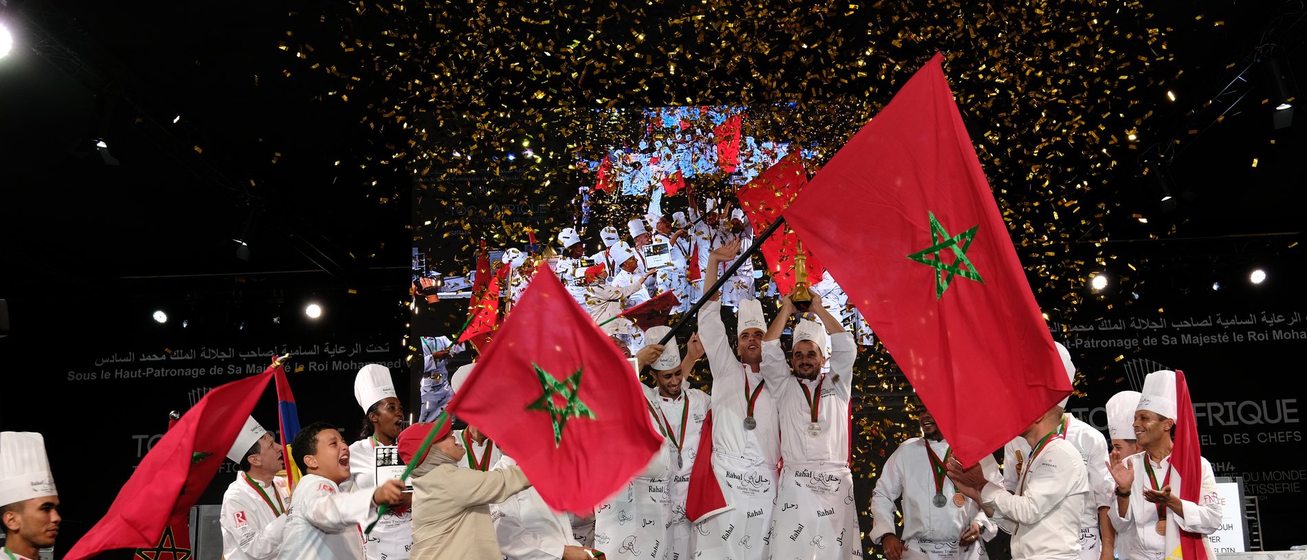 Winning team raising the trophy, Moroccan flags and gold confetti, Bocuse d'Or Africa 2024